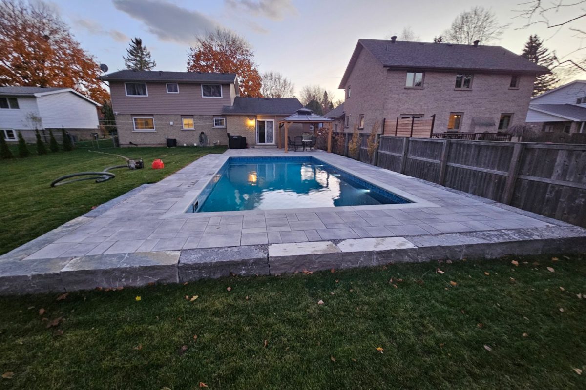 Completed in-ground pool with stone decking in Beaverton, Ontario