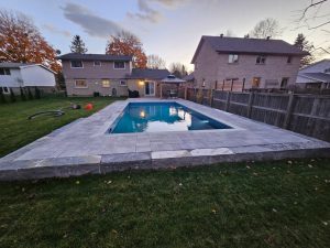 Completed in-ground pool with stone decking in Beaverton, Ontario